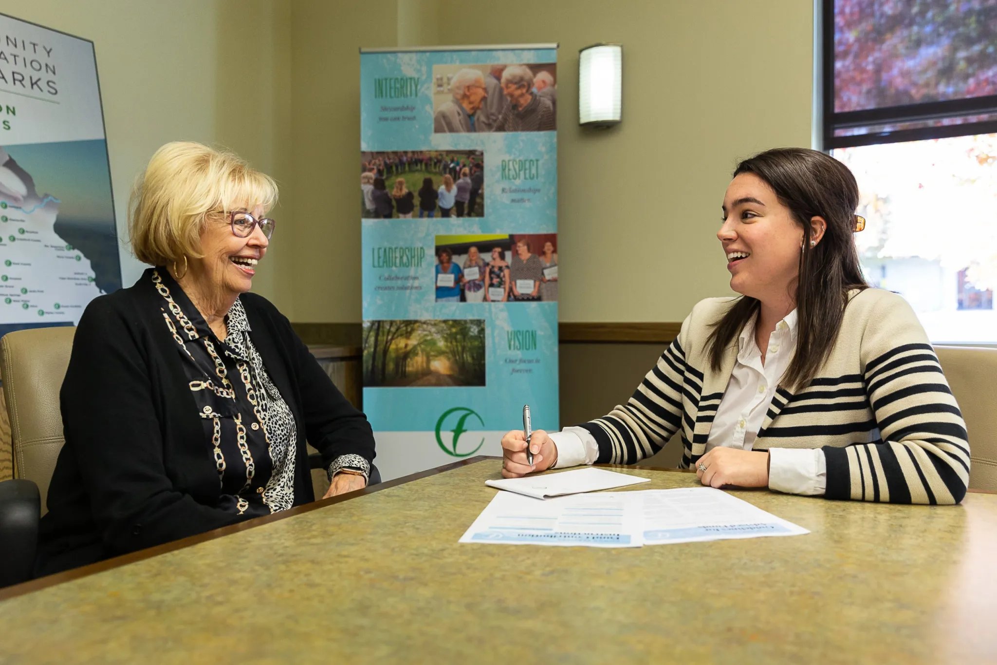 Patti Penny, founder of Penmac Staffing, chats with Caitlin Golike, director of donor services for the CFO, during a donor meeting at the CFO’s main office in Springfield. Penny has opted to donate her ownership shares of Penmac to support her charitable giving. (Photo provided by Community Foundation of the Ozarks)